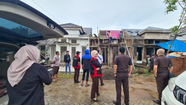 Petugas Kejati Sulsel yang melakukan penyitaan aset rumah tersangka kasus hilangnya ratusan ton beras Bulog Pinrang (ist)