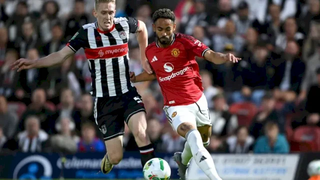 Matheus Cunha dari Manchester United beradu bersama Harvey Rodgers dari Grimsby/Shaun Botterill/Getty Images/ 