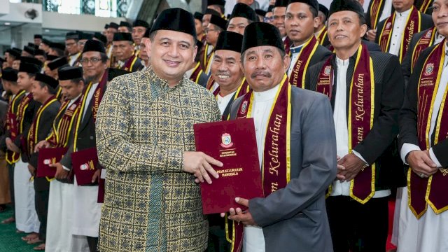 Wali Kota Makassar, Munafri Arifuddin, menyerahkan dokumen pelantikan kepada salah satu dari 153 Imam Kelurahan dalam acara Tabligh Akbar dan Pelantikan Imam Kelurahan se-Kota Makassar di Masjid Al Markaz Al Islami, Kamis (25/6/2026).