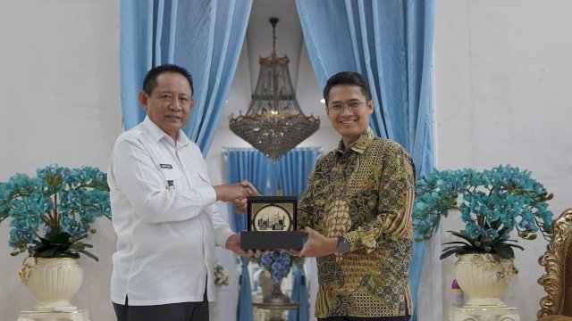 Gubernur Gorontalo, Dr. Ir. H. Gusnar Ismail, M.M. (kiri), menerima plakat dari General Manager PT PLN (Persero) UIP Sulawesi, I Gusti Made Aditya San Adinatha (kanan)